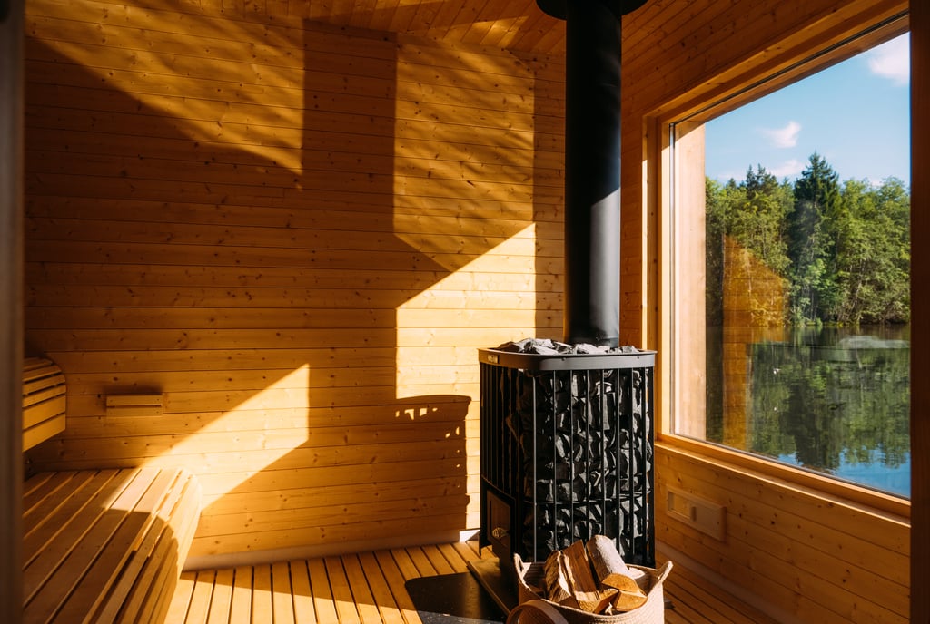 Moderne badstue med trevegger, peis og utsikt over naturen. Perfekt for avslapning og velvære.